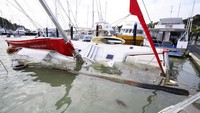 Selandia Baru menjadi salah satu negara yang terdampak dahsyatnya erupsi Gunung Bawah Laut Tonga. Sejumlah perahu di marina yang berada di kawasan Tutukaka, Selandia Baru, tampak rusak dan terendam, Minggu (16/1/2022). Tanya White/Northern Advcate/NZME via AP.