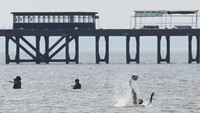 Orang-orang melakukan pendinginan di Rio de la Plata di tengah gelombang panas musim panas di Buenos Aires, Argentina. (AP/Maria De Fina)