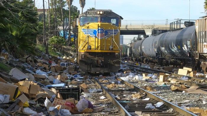 Shredded boxes and packages are seen at a section of the Union Pacific train tracks in downtown Los Angeles Friday, Jan. 14, 2022. Thieves have been raiding cargo containers aboard trains nearing downtown Los Angeles for months, leaving the tracks blanketed with discarded packages. The sea of debris left behind included items that the thieves apparently didn't think were valuable enough to take, CBSLA reported Thursday. (AP Photo/Ringo H.W. Chiu)