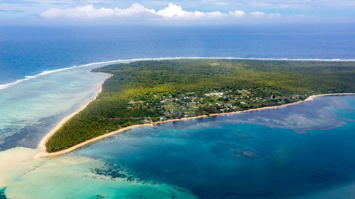 Aerial view of rural Uiha Island near Lifuka, the Haapai Group, Haapai, Haapai islands, Kingdom of Tonga, Polynesia, Oceania, South Pacific Ocean. Palms, yellow sandy beaches and villages.