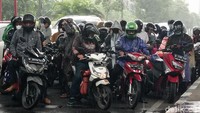 Banyaknya pemotor yang berteduh membuat arus lalu lintas menjadi tersendat.
