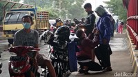 Para pemotor berteduh karena tidak membawa jas hujan.