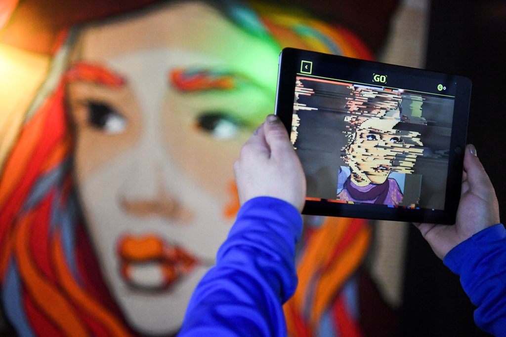 FILE PHOTO: Hands holding a tablet computer are pictured during a tour through the urban NFT LAB called 