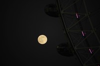 The first full moon of the year known as a Wolf Moon is seen behind different clock faces showing different times, with the correct time at right, as refurbishment work continues on the Elizabeth Tower, known as Big Ben, and the Houses of Parliament, in London, Monday, Jan. 17, 2022. (AP Photo/Matt Dunham)
