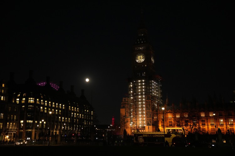 Britain Moon The first full moon of the year known as a Wolf Moon is seen behind different clock faces showing different times, with the correct time at right, as refurbishment work continues on the Elizabeth Tower, known as Big Ben, and the Houses of Parliament, in London, Monday, Jan. 17, 2022. (AP Photo/Matt Dunham)