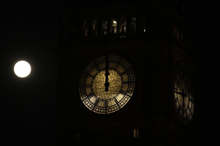 Britain Moon The first full moon of the year known as a Wolf Moon is seen behind different clock faces showing different times, with the correct time at right, as refurbishment work continues on the Elizabeth Tower, known as Big Ben, and the Houses of Parliament, in London, Monday, Jan. 17, 2022. (AP Photo/Matt Dunham)
