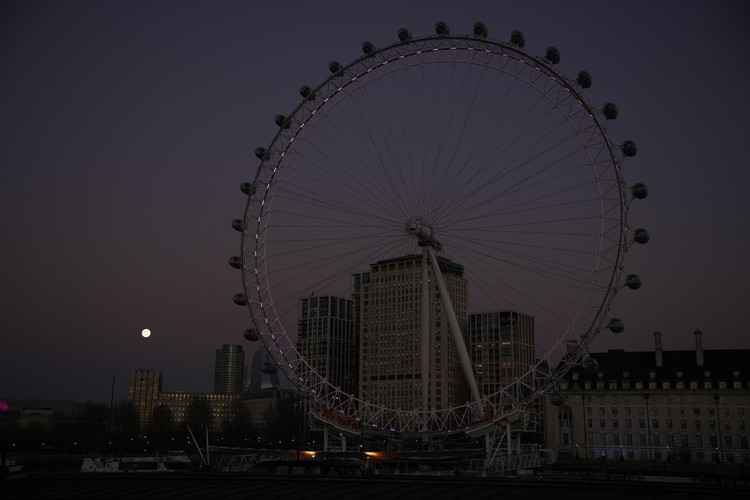 Britain Moon The first full moon of the year known as a Wolf Moon is seen behind different clock faces showing different times, with the correct time at right, as refurbishment work continues on the Elizabeth Tower, known as Big Ben, and the Houses of Parliament, in London, Monday, Jan. 17, 2022. (AP Photo/Matt Dunham)