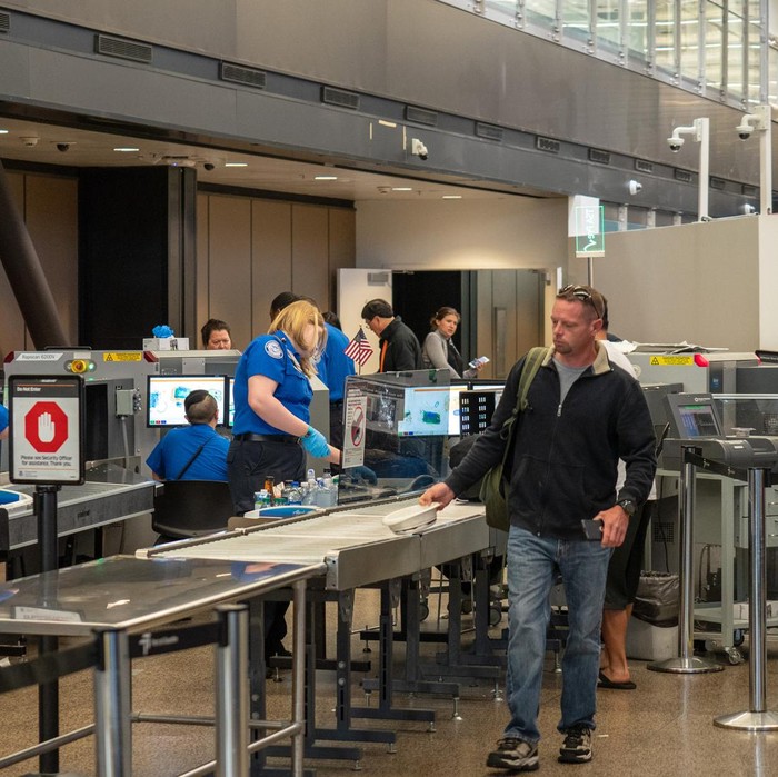 Seattle, WA AUGUST 26, 2018: Man passes though Transportation Security Administration TSA security checkpoint at Seattle-Tacoma International Airport.