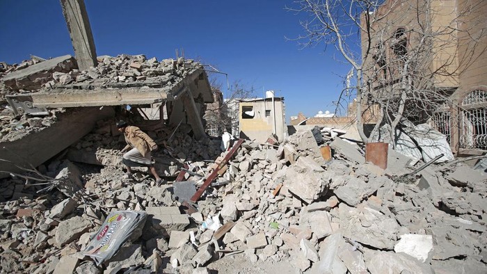People inspect the wreckage of buildings that were damaged by Saudi-led coalition airstrikes, in Sanaa, Yemen, Tuesday, Jan. 18, 2022. The coalition fighting in Yemen announced it had started a bombing campaign targeting Houthi sites a day after a fatal attack on an oil facility in the capital of the United Arab Emirates claimed by Yemen’s Houthi rebels. It said it also struck a drone operating base in Nabi Shuaib Mountain near Sanaa. (AP Photo/Hani Mohammed)