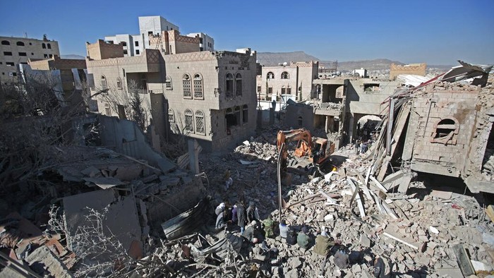 People inspect the wreckage of buildings that were damaged by Saudi-led coalition airstrikes, in Sanaa, Yemen, Tuesday, Jan. 18, 2022. The coalition fighting in Yemen announced it had started a bombing campaign targeting Houthi sites a day after a fatal attack on an oil facility in the capital of the United Arab Emirates claimed by Yemen’s Houthi rebels. It said it also struck a drone operating base in Nabi Shuaib Mountain near Sanaa. (AP Photo/Hani Mohammed)