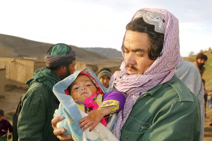 An Afghan man hold his injured daughter after his home was damaged by Monday's earthquake in the remote western province of Badghis, Afghanistan, Tuesday, Jan. 18, 2022.   The United Nations on Tuesday raised the death toll from Monday's twin earthquakes in western Afghanistan,  saying three villages of around 800 houses were flattened by the temblors.   (Abdul Raziq Saddiqi)