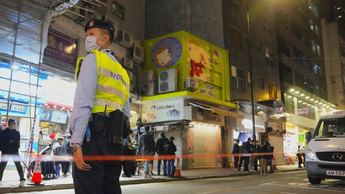 Staff members from Agriculture, Fisheries and Conservation Department investigate in a pet shop closed after some pet hamsters authorities said, tested positive for the coronavirus, in Hong Kong, Tuesday, Jan. 18, 2022. Hong Kong authorities said Tuesday that they will cull some 2,000 hamsters after several of the rodents tested positive for delta variant at the pet store where an infected employee was working. (AP Photo/Kin Cheung)