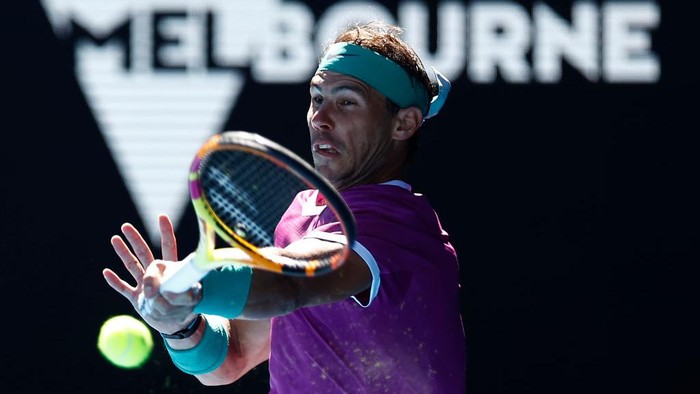 MELBOURNE, AUSTRALIA - JANUARY 19: Rafael Nadal of Spain plays a forehand in his second round singles match against Yannick Hanfmann of Germany during day three of the 2022 Australian Open at Melbourne Park on January 19, 2022 in Melbourne, Australia. (Photo by Daniel Pockett/Getty Images)