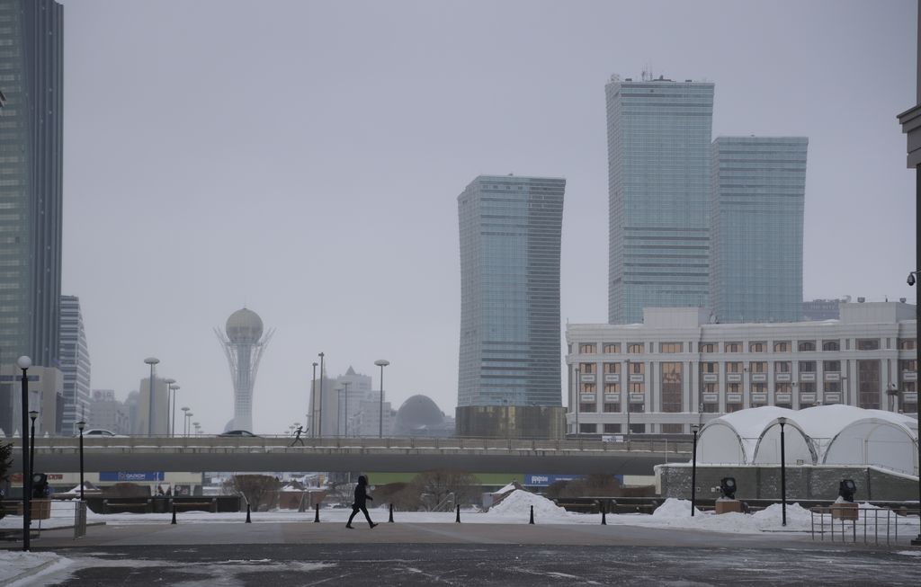 FILE - In this Wednesday, Jan. 25, 2017 file photo, a person walks along a street in Astana, Kazakhstan. The parliament of the Central Asian nation of Kazakhstan on Wednesday March 20, 2019, has voted to rename the country’s capital to Nursultan, after the outgoing longtime leader. (AP Photo/Sergei Grits, File)