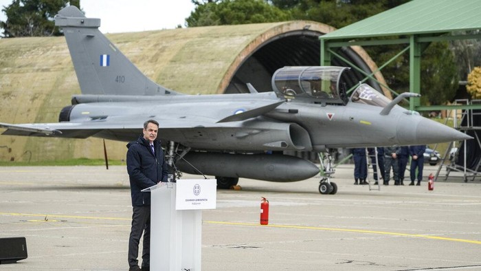 Guests take photographs of a Rafale fighter during a handover ceremony in Tanagra military air base, about 82 kilometres (51miles) north of Athens, Greece, on Wednesday, Jan. 19, 2022. Six advanced-tech Rafale jets bought from the French air force were handed over Wednesday to the Greek armed forces ‒ the first major delivery to result from multi-billion euro defense deals sealed with Paris last year. (AP Photo/Thanassis Stavrakis)