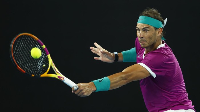 MELBOURNE, AUSTRALIA - JANUARY 21:  Rafael Nadal of Spain plays a backhand in his third round singles match against Karen Khachanov of Russia during day five of the 2022 Australian Open at Melbourne Park on January 21, 2022 in Melbourne, Australia. (Photo by Daniel Pockett/Getty Images)