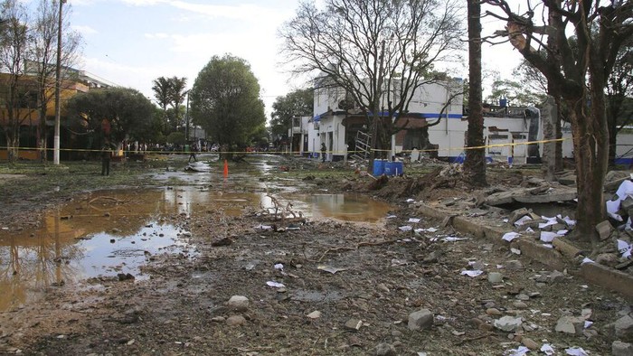 Debris litters an area caused by a car bomb in Saravena, Arauca, Colombia, Thursday, Jan. 20, 2022. The car bomb exploded late Wednesday, killing one person and injuring at least four others, according to police. (AP Photo/Mike Caceres)