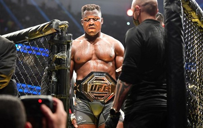 UFC 270 heavyweight world champion Cameroons Francis Ngannou (C) celebrates victory over Frances Ciryl Gane after their fight for the heavyweight title at the Honda Center in Anaheim, California on January 22, 2022. (Photo by Frederic J. BROWN / AFP)