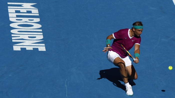 Rafael Nadal of Spain makes a backhand return to Adrian Mannarino of France during their fourth round match at the Australian Open tennis championships in Melbourne, Australia, Sunday, Jan. 23, 2022. (AP Photo/Hamish Blair)