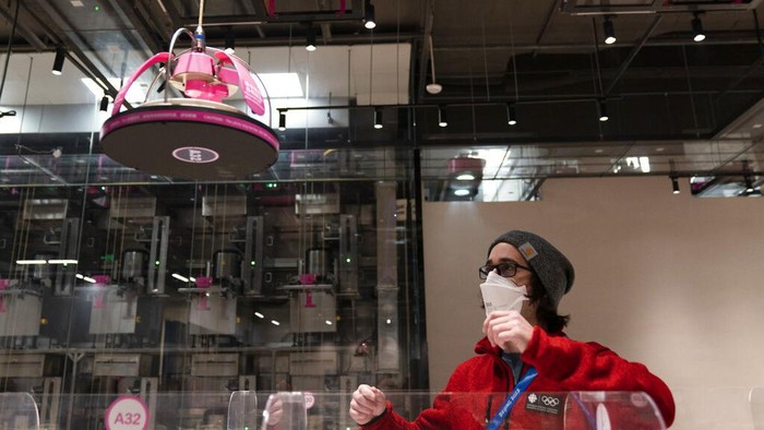 Food is delivered to a table robotically in the dining area of the main media center at the 2022 Winter Olympics, Monday, Jan. 24, 2022, in Beijing. (AP Photo/Jae C. Hong)