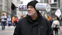 Dalam aksinya para demonstran membawa poster dan beragam atribut lainnya sebagai bentuk kritik dan penolakan terhadap aturan pembatasan akibat COVID-19, salah satunya terkait vaksinasi. AP Photo/Geert Vanden Wijngaert.