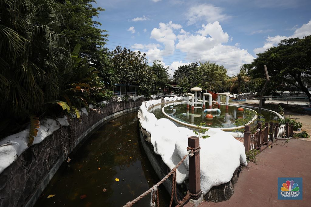 Pekerja melakukan perancangan proyek revitalisasi Taman Mini Indonesia Indah (TMII), Senin (24/1/2022). Snowbay Waterpark dulunya dikenal sebagai wahana favorit anak-anak, sayangnya karena COVID-19, kolam renang dengan berbagai wahana itu harus ditutup selama nyaris 2 tahun. Beberapa kondisi fisik yang terbengkalai terlihat dilokasi ini mulai pintu masuk tiket dan rak tempat penitipan barang. Kondisi Snowbay Waterpark saat ini memang tak terurus karena sudah lama tutup. Sejumlah kolam renang dibiarkan begitu saja hingga airnya keruh. Terlihat juga toko-toko yang dulu menjual perlengkapan renang dan kuliner juga tutup.  Dikutip dari situs tamanmini.com, Snowbay Waterpark mulanya dirancang secara khusus sebagai taman rekreasi petualangan berkelas dunia berkonsep pegunungan saljuTaman seluas 3 hektar ini dibangun tahun 2008 dan diresmikan pembukaannya oleh ketua Yayasan harapan Kita, Hj. Siti Hardiyanti Rukmana pada tanggal 19 April 2009. Sebelumnya, taman ini adalah Taman Rekreasi Ambar Tirta. (վ/ Tri Susilo)