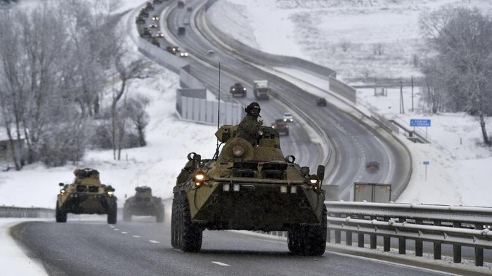 FILE - A convoy of Russian armored vehicles moves along a highway in Crimea, Tuesday, Jan. 18, 2022. With tens of thousands of Russian troops positioned near Ukraine, the Kremlin has kept the U.S. and its allies guessing about its next moves in the worst Russia-West security crisis since the Cold War. (AP Photo, File)