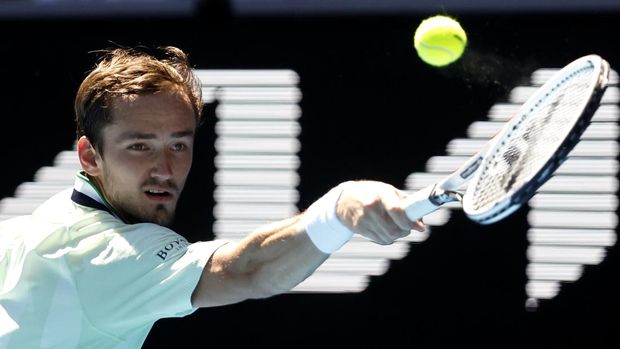 Daniil Medvedev of Russia makes a backhand return to Maxime Cressy of the U.S. during their fourth round match at the Australian Open tennis championships in Melbourne, Australia, Monday, Jan. 24, 2022. (AP Photo/Hamish Blair)