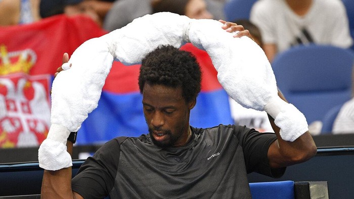 Gael Monfils of France places an ice towel around his neck during break in his fourth round match against Miomir Kecmanovic of Serbia at the Australian Open tennis championships in Melbourne, Australia, Sunday, Jan. 23, 2022. (AP Photo/Andy Brownbill)
