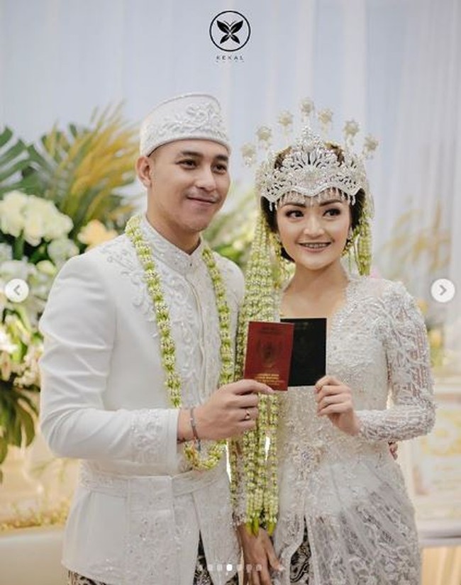 Penampilan pedangdut Siti Badriah saat menikah juga tak kalah mencuri perhatian. Resmi menikahi Krisjiana Baharudin pada 25 Juli 2019, Siti Badriah tampil anggun dalam balutan kebaya pengantin Sunda berwarna putih. Lengkap dengan siger dan riasan wajah, penampilan Siti Badriah kian memesona. Foto: Instagram