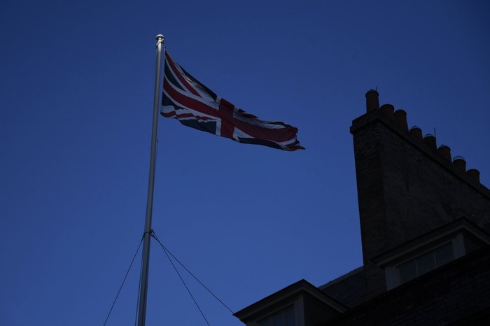 FILE - In this file photo dated Monday, Dec. 14, 2020, the Union Flag flies on the top of 10 Downing Street, the Prime Ministers official residence in London. The British government said Wednesday March 24, 2021, the national flag should be flown every day on all public buildings, the latest move in an increasing embrace of the Union flag. (AP Photo/Alberto Pezzali, FILE)