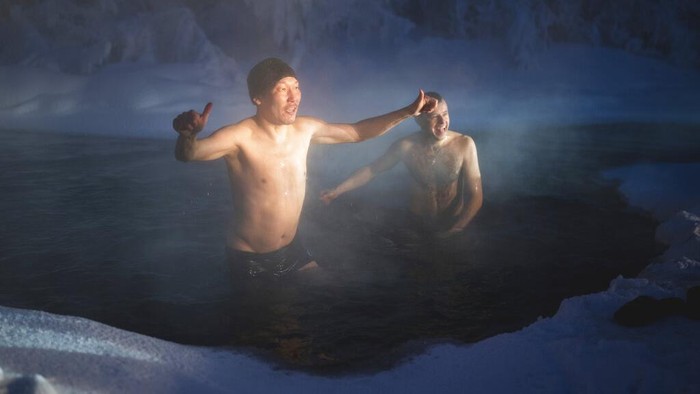 A runner looks at a photographer after taking part in the International World's coldest marathon at minus 53 degrees (-63.4 Fahrenheit) near Oymyakon, the republic of Sakha, also known as Yakutia, Russian Far East, Saturday, Jan. 22, 2022. Sixty five runners, including sportsmen from the United Arab Emirates, United States and Belarus, started the run at extremely low temperature in Oymyakon, Yakutia's Pole of Cold. The international team of men and women ran full distance and half-marathon. (AP Photo/Ivan Nikiforov)