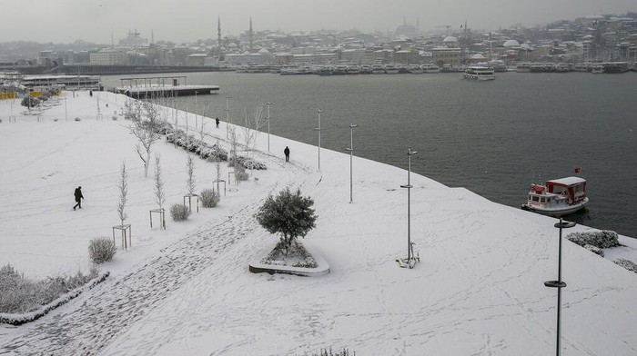 People throw snowballs each other on the snow-covered park in Istanbul, Turkey, on Monday, Jan. 24, 2022. A severe snowstorm disrupted road and air traffic Monday in the Greek capital of Athens and in neighboring Turkey's largest city of Istanbul, while snow blanketed most of Turkey and Greece, including several Aegean islands. (AP Photo/Emrah Gurel)