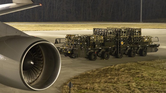 In this image provided by the U.S. Air Force, Airmen and civilians from the 436th Aerial Port Squadron palletize ammunition, weapons and other equipment bound for Ukraine during a foreign military sales mission at Dover Air Force Base, Del., Jan. 21, 2022. Since 2014, the U.S. has committed more than $5.4 billion in total assistance to Ukraine, including security and non-security assistance.(Mauricio Campino/U.S. Air Force via AP)