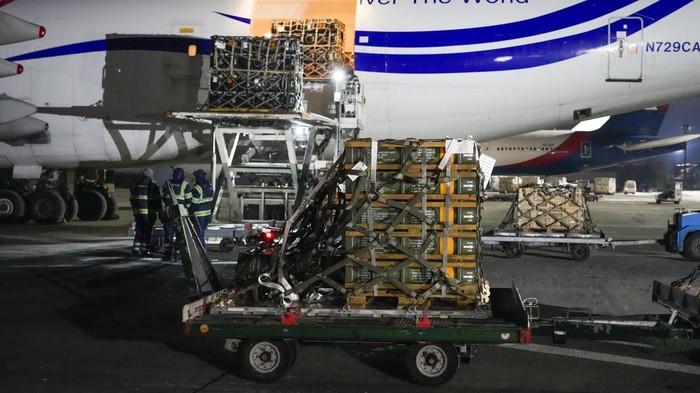 In this image provided by the U.S. Air Force, Airmen and civilians from the 436th Aerial Port Squadron palletize ammunition, weapons and other equipment bound for Ukraine during a foreign military sales mission at Dover Air Force Base, Del., Jan. 21, 2022. Since 2014, the U.S. has committed more than $5.4 billion in total assistance to Ukraine, including security and non-security assistance.(Mauricio Campino/U.S. Air Force via AP)