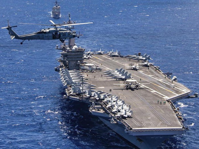 FILE -- In this photo provided by the U.S. Navy, the aircraft carrier USS Carl Vinson participates in a group sail during the Rim of the Pacific exercise off the coast of Hawaii, July 26, 2018. The U.S. military says a Navy F35C Lightning II combat jet conducting exercises in the South China Sea has crashed while trying to land on the deck of the USS Carl Vinson, injuring seven sailors, Monday, Jan. 24, 2022, the military said. (Petty Officer 1st Class Arthurgwain L. Marquez/U.S. Navy via AP, File)
