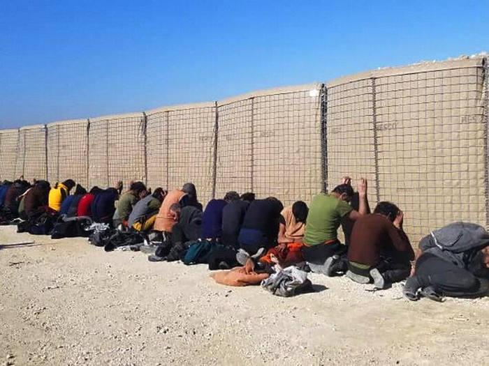 This photo provided by the Kurdish-led Syrian Democratic Forces, shows some Islamic State group fighters, who surrendered after clashing with Kurdish-led Syrian Democratic Forces, at Gweiran Prison, in Hassakeh, northeast Syria, Monday, Jan. 24, 2022. Clashes between U.S.-backed Syrian Kurdish fighters and militants continued for a fourth day Sunday near the prison in northeastern Syria that houses thousands of members of IS, the Kurdish force said.
