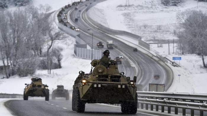 FILE - A convoy of Russian armored vehicles moves along a highway in Crimea, Tuesday, Jan. 18, 2022. With tens of thousands of Russian troops positioned near Ukraine, the Kremlin has kept the U.S. and its allies guessing about its next moves in the worst Russia-West security crisis since the Cold War. (AP Photo, File)