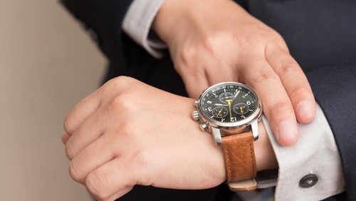 Businessman checking the time on his wrist watch