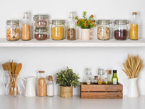 rak bumbu dapur Modern kitchen shelves with various food ingredients on white background