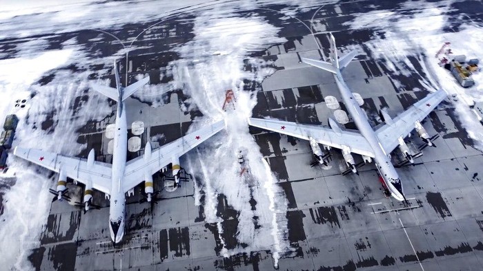 In this image taken from video provided by the Russian Defense Ministry Press Service, a pair of Tu-95 strategic bombers of the Russian air force are parked at an air base in Engels near the Volga River in Russia, Monday, Jan. 24, 2022. Russia has intensified military drills amid tensions with the West over the buildup of an estimated 100,000 Russian troops near Ukraine that fueled Western fears of an invasion. (Russian Defense Ministry Press Service via AP)