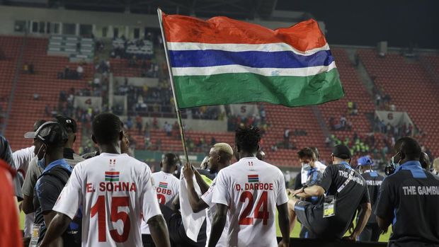 Gambia players celebrate at the end of the African Cup of Nations 2022 round of 16 match between Guinea and Gambia at Kouekong Stadium, Bafoussam, Cameroon, Monday, Jan. 24, 2022. (AP Photo/Sunday Alamba)