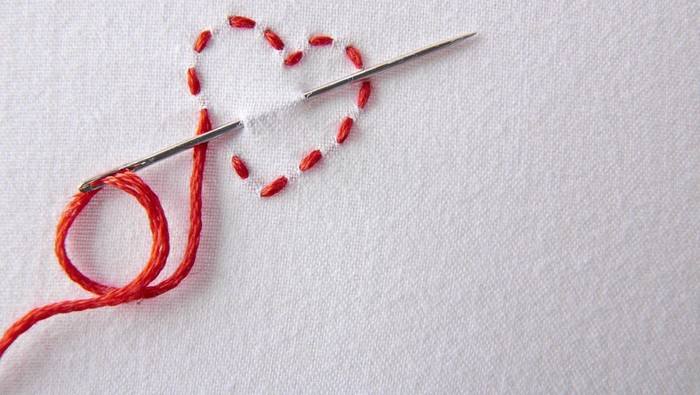 ilustrasi husband stitch Embroidered red heart on a white cloth close up. Concept passion for sewing and embroidery. Horizontal composition.Top view