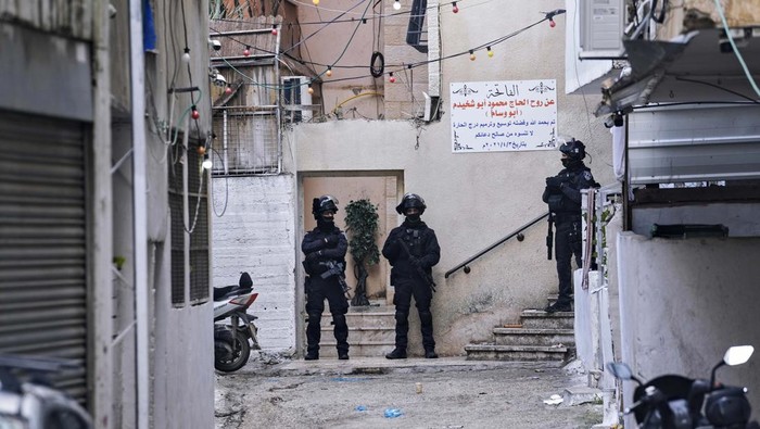 Israeli security forces prepare to seal up the family home of Palestinian militant Fadi Abu Shkhaidem, in the Shuafat refugee camp in Jerusalem, Tuesday, Feb. 1, 2022. Abu Shkhaidem was fatally shot by Israeli police after he killed one Israeli and wounded four others in a shooting attack in Jerusalems Old City in Nov. 2021, and the sealing of the home is seen as a deterrent for other would be attackers. (AP Photo/Mahmoud Illean)