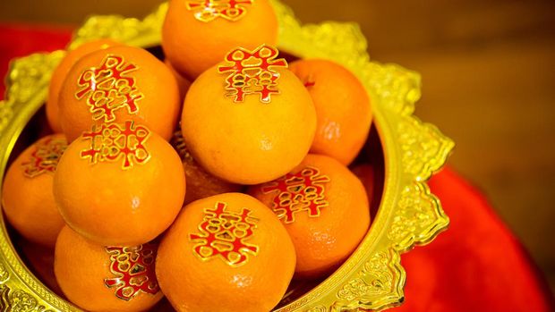 Oranges pile, on gold plated for worship in the Chinese New Year.chinese New Year's Eve Celebration.Influence of religion on festivals. image for illustration, copy space and article.