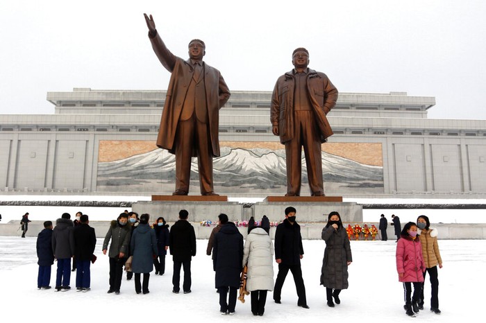 People visit the statues of former North Korean leaders Kim Il Sung, left, and Kim Jong Il on Mansu Hill in Pyongyang, North Korea, on the occasion of Lunar New Year holidays on Tuesday, Feb. 1, 2022. (AP Photo/Jon Chol Jin)