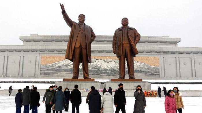 People visit the statues of former North Korean leaders Kim Il Sung, left, and Kim Jong Il on Mansu Hill in Pyongyang, North Korea, on the occasion of Lunar New Year holidays on Tuesday, Feb. 1, 2022. (AP Photo/Jon Chol Jin)