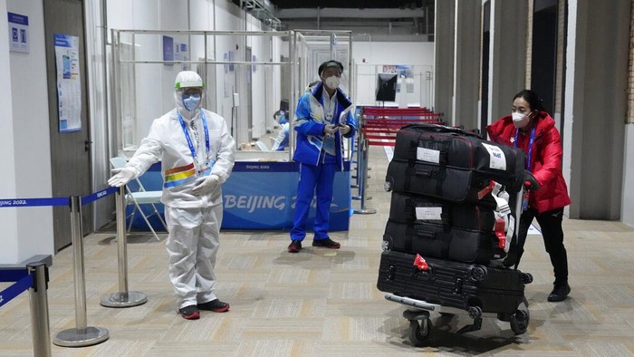 A member of Team Japan arrives at the Olympic Village for the 2022 Winter Olympics, Jan. 30, 2022, in Beijing. (AP Photo/Mark Schiefelbein)