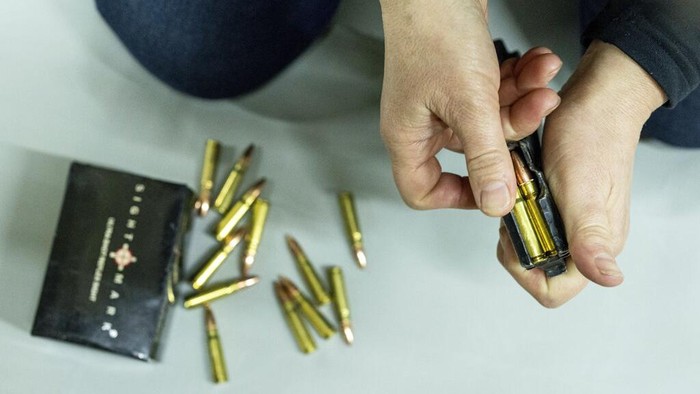 An instructor shows how to use weapons to a group of women during training in Kharkiv, Ukraine, Sunday, Jan. 30, 2022. Some people in Ukraine's second-largest city are preparing to fight back if Russia invades. Kharkiv is just 40 kilometers (25 miles) from some of the tens of thousands of Russian troops massed at the border. (AP Photo/Evgeniy Maloletka)
