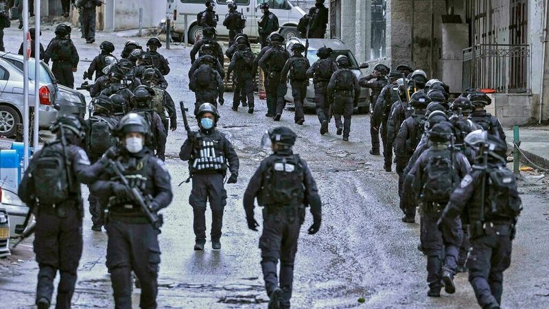 Israeli forces secure the area around the family home of Palestinian Hamas member Fadi Abu Shkhaydam before the demolition (HAZEM BADER/AFP)